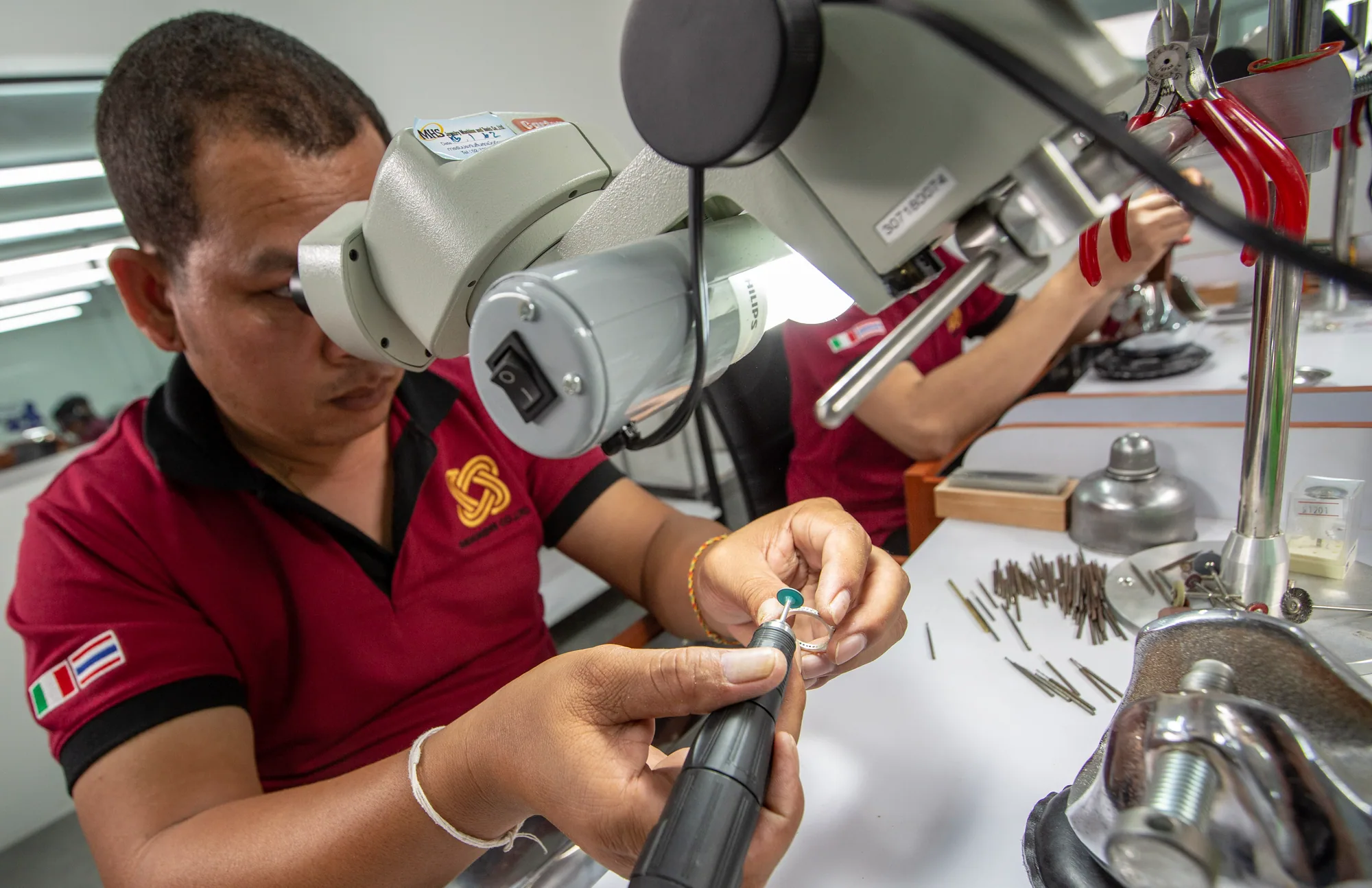 Stone setter at the microscope in the Bangkok workshop